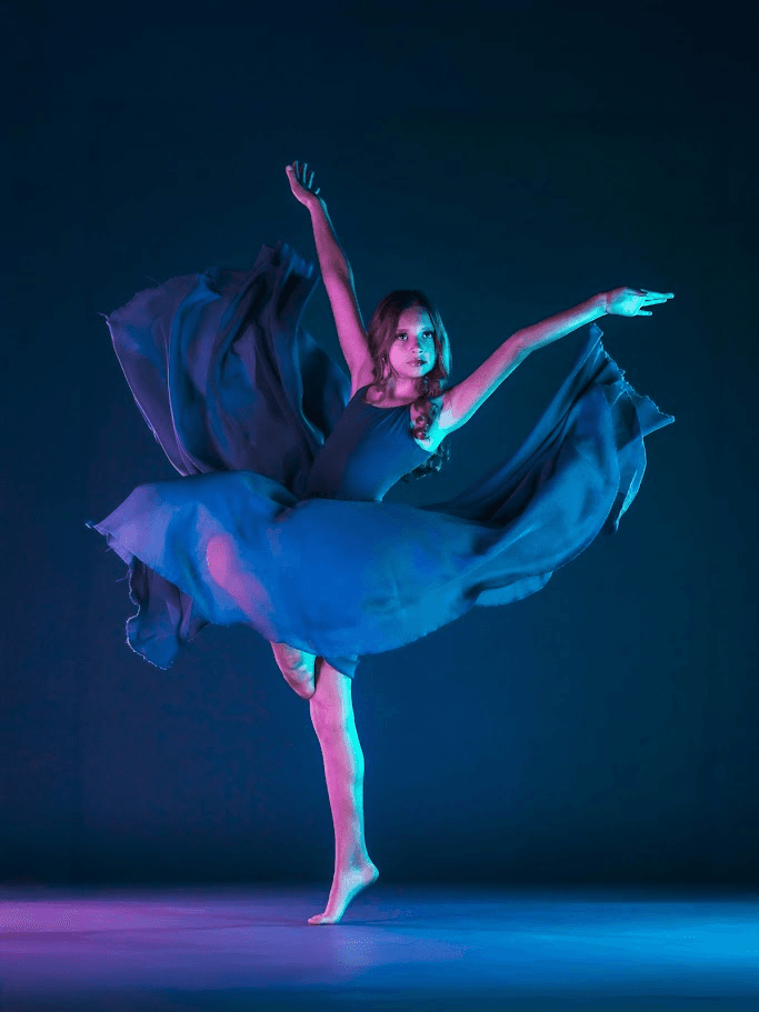 Emerging dancer performing in a flowing blue dress