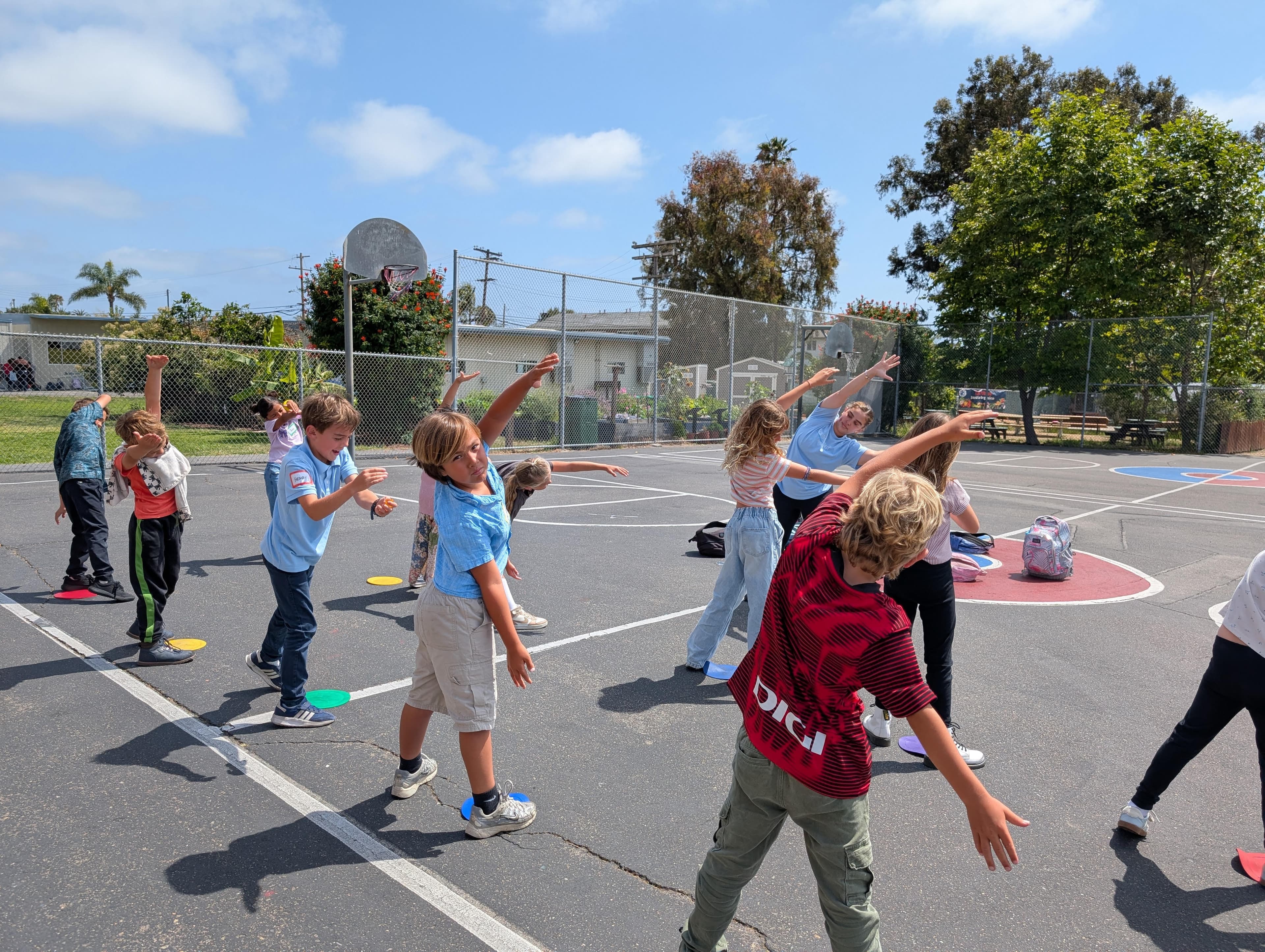 Students practicing dance on a public school campus